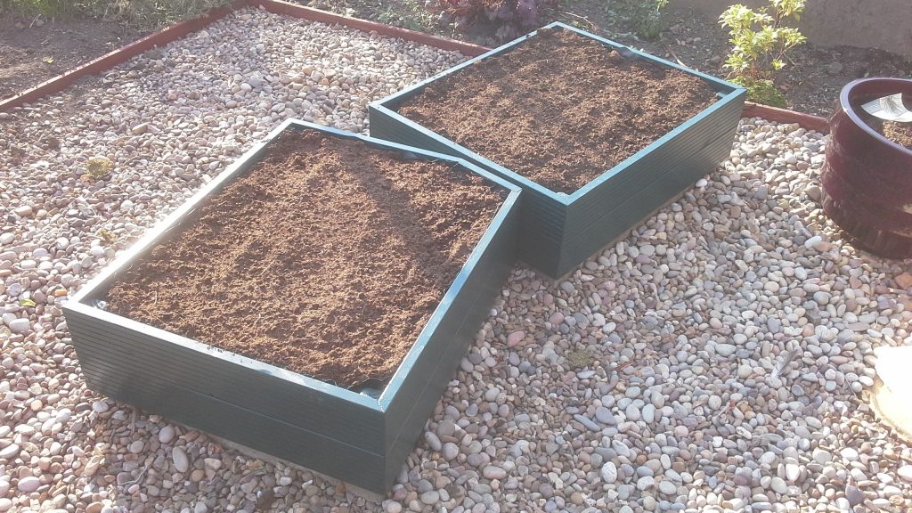Planters painted in dark green and ready for planting - Garden Planter Maintenance